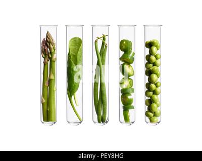 Vegetables in test tubes, studio shot. Stock Photo