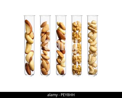 Nuts in test tubes, studio shot. Stock Photo