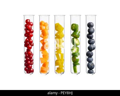 Fruits and vegetables in test tubes, studio shot. Stock Photo