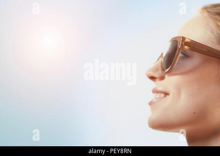 Woman wearing sunglasses, smiling. Stock Photo