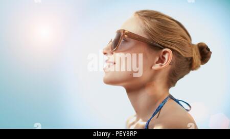Woman wearing sunglasses, smiling. Stock Photo