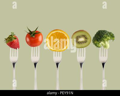 Fresh fruit and vegetables on forks. Stock Photo