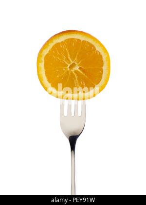 Orange cut in half on a fork. Stock Photo