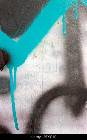 Blue, silver and black spray paint details on old cement wall Stock Photo