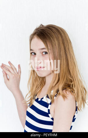 Cute girl eleven years old with blond long hair on white background Stock  Photo - Alamy