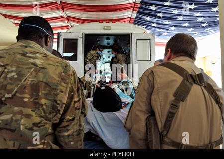 A 455th Expeditionary Medical Group team combines efforts with the Extracorporeal Membrane Oxygenation team to save the life of a NATO ally at the Craig Joint-Theater Hospital at Bagram Air Field, Afghanistan, on Feb. 18, 2016. The ECMO team, dispatched from San Antonio Military Medical Center, uses technology that bypasses the lungs and infuses the blood directly with oxygen, while removing the harmful carbon dioxide from the blood stream. The patient was airlifted to Landstuhl Regional Medical Center, Germany, where he will receive 7 to 14 days of additional ECMO treatment. (U.S. Air Force p Stock Photo