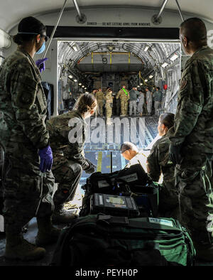 A 455th Expeditionary Medical Group team prepares to load the remaining equipment used to save the life of a NATO ally, who required Extracorporeal Membrane Oxygenation team support, onto an aeromedical evacuation transport at Bagram Air Field, Afghanistan, on Feb. 18, 2016. The ECMO team, dispatched from San Antonio Military Medical Center, uses technology that bypasses the lungs and infuses the blood directly with oxygen, while removing the harmful carbon dioxide from the blood stream. The patient was airlifted to Landstuhl Regional Medical Center, Germany, where he will receive 7 to 14 days Stock Photo