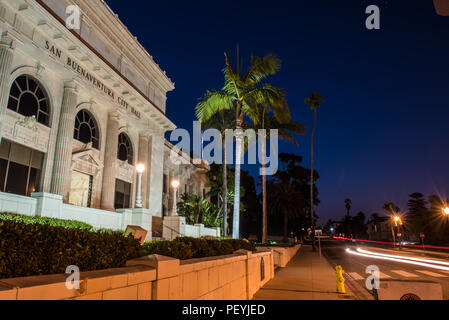 Dawn breaking over Ventura City Hall building lit up at night with landscaping and Junipero Serra statue in front on August 17, 2018 in California, US Stock Photo