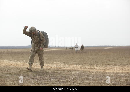 A Paratrooper with 82nd Airborne Division walks off of Sicily Drop Zone at Fort Bragg, N.C., following a static line jump during the Saturday Proficiency Jump Program (SPJP) on Feb. 20, 2016. The SPJP builds proficiency, experience, and confidence of individual Paratroopers, ensuring the XVIII Airborne Corps remains ready for contingency response missions. (US Army Photo by Sgt. Tierney P. Curry)(Released) Stock Photo