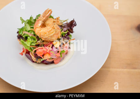 A prawn salad with beets on a white plate. Stock Photo