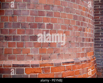 Curved garden plain brick wall, in english victorian house estate garden Stock Photo