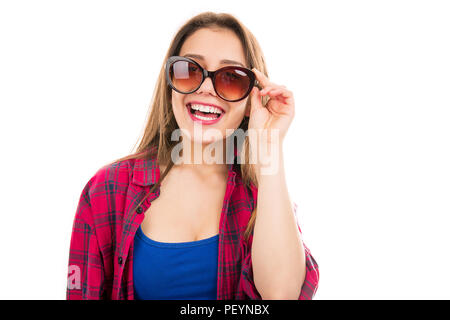 Pretty young teen woman in checkered shirt wearing trendy sunglasses smiling at camera isolated on white background Stock Photo