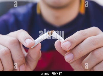 Stop cigarette, man hands breaking the cigarette with clipping path Stock Photo