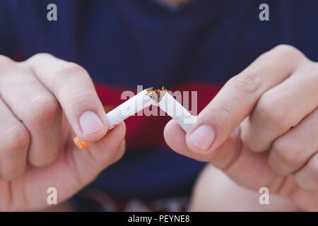 Stop cigarette, man hands breaking the cigarette with clipping path Stock Photo