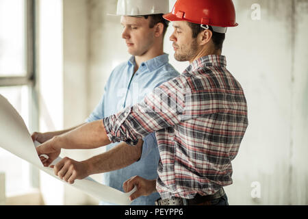 two engineers are making up the project at workplace.social service buildings Stock Photo