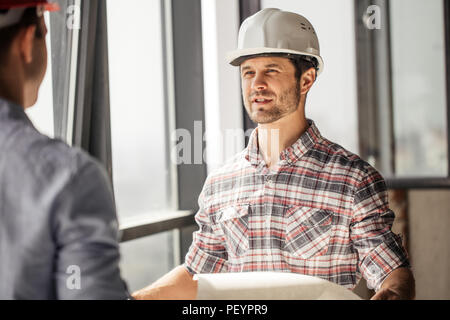 good looking construction worker sharing with the experience with a colleague Stock Photo