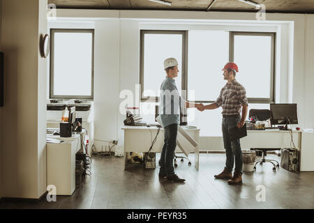 Business teamwork concept. full length photo. positive architects are arranging a settlement Stock Photo