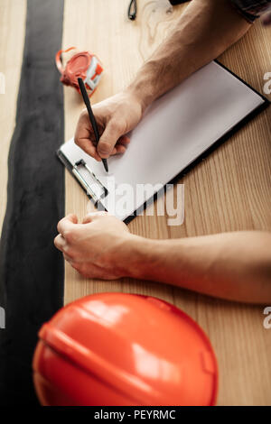 drawing concept. creation of project. paperwork. top view photo. busy engineer is making notes on the sheet of paper Stock Photo