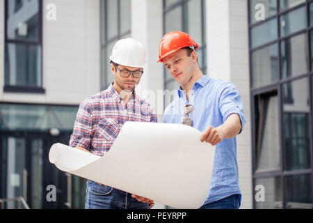 two architects are developing a business plan. close up photo. modern building on the background of the photo Stock Photo