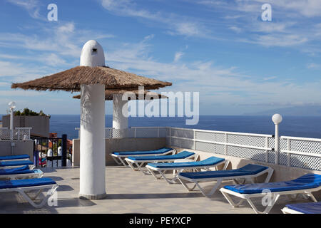 LOS GIGANTES, TENERIFE/SPAIN - FEBRUARY 20 : Parasols and sun loungers on a hotel roof in Los Gigantes Tenerife on February 20, 2011 Stock Photo