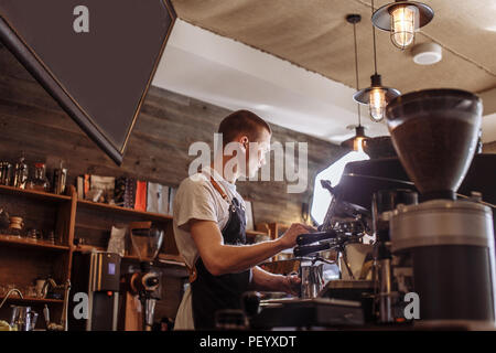 a pleasant waiter is taking orders at the cafe Stock Photo