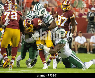 Washington Redskins running back Rob Kelley (20) is tackled by four New York Jets defensive players including defensive tackle Leonard Williams (92) and linebacker Jordan Jenkins (48) in first quarter action at FedEx Field in Landover, Maryland on Thursday, August 16, 2018. Credit: Ron Sachs/CNP (RESTRICTION: NO New York or New Jersey Newspapers or newspapers within a 75 mile radius of New York City) | usage worldwide Credit: dpa picture alliance/Alamy Live News Stock Photo
