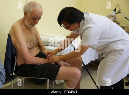 Paola, Malta. 17th Aug, 2018.Chinese doctor An Jing (R) practices acupuncture treatment on a patient at the Mediterranean Regional Center for Traditional Chinese Medicine (MRCTCM) in Paola city, Malta, Aug. 17, 2018. The MRCTCM was officially established in 1994 as a partnership between the Chinese and Maltese governments. The health department of China's eastern Jiangsu province is responsible for dispatching medical teams biennially. Credit: Yuan Yun/Xinhua/Alamy Live News Stock Photo