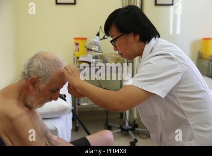 Paola, Malta. 17th Aug, 2018.Chinese doctor An Jing (R) practices acupuncture treatment on a patient at the Mediterranean Regional Center for Traditional Chinese Medicine (MRCTCM) in Paola city, Malta, Aug. 17, 2018. The MRCTCM was officially established in 1994 as a partnership between the Chinese and Maltese governments. The health department of China's eastern Jiangsu province is responsible for dispatching medical teams biennially. Credit: Yuan Yun/Xinhua/Alamy Live News Stock Photo