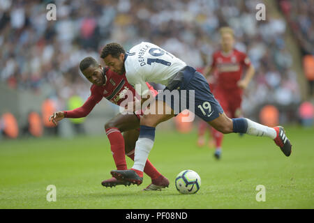 London, UK. 18th August 2018. Mousa Dembele of Tottenham Hotspur in a clash with Ryan Sessegnon of Fulham during the Tottenham Hotspur vs Fulham, Premier League football match 0n 18th August 2018.  EDITORIAL USE ONLY No use with unauthorised audio, video, data, fixture lists (outside the EU), club/league logos or 'live' services. Online in-match use limited to 45 images (+15 in extra time). No use to emulate moving images. No use in betting, games or single club/league/player publications/services. Credit: MARTIN DALTON/Alamy Live News