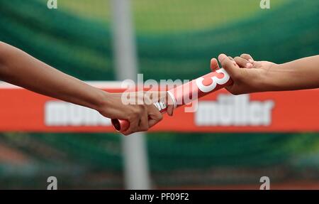 Birmingham, UK. 18th August 2018. Handing over the baton. Relay race. Muller Grand Prix Birmingham. Diamond league. Alexander Stadium. Perry Bar. Birmingham. UK. 18/08/2018. Credit: Sport In Pictures/Alamy Live News Stock Photo