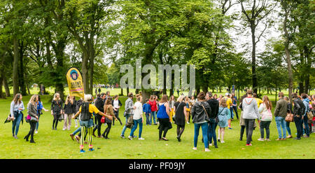 Edinburgh Fringe Festival, Edinburgh, UK. 18th August 2018. The Meadows, Edinburgh, Scotland United Kingdom: Despite a damp cloudy day, Fringe goers enjoy the shows on the third weekend of the festival. A silent disco Fringe show called The Silent Adventures takes people on a tour wearing headphones Stock Photo