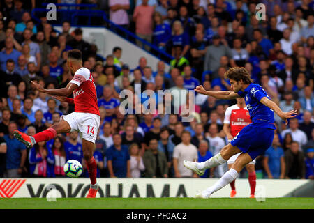 London, UK. 18th August 2018. Marcus Alonso of Chelsea (L) takes a shot for goal. Premier League match, Chelsea v Arsenal at Stamford Bridge in London on Saturday 18th August 2018.  this image may only be used for Editorial purposes. Editorial use only, license required for commercial use. No use in betting, games or a single club/league/player publications. pic by Steffan Bowen/ Andrew Orchard sports photography/Alamy Live news Stock Photo