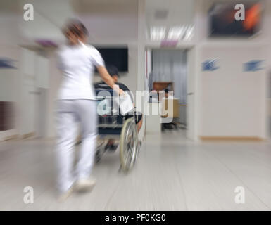 Blurred image of unidentified people with nurse in hospital waiting for doctor in waiting room Stock Photo