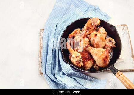 Fried chicken legs in  iron frying pan. Top view Stock Photo