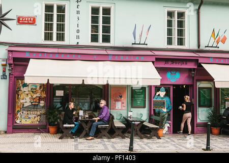 Prague, September 25, 2017: A popular restaurant with local Czech food. Visitors sit at tables outside. Near the hotel. The waiter serves customers Stock Photo