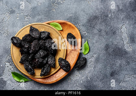 Dried prunes on plate. Top view of peeled plums. Top view. Stock Photo