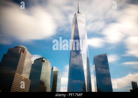 Fast moving clouds over One WTC and the 9/11 memorial in Lower Manhattan, New York City. Stock Photo