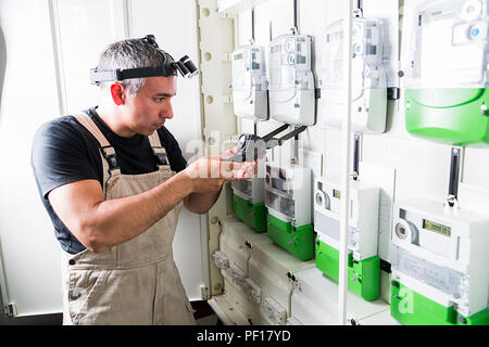 Electrician testing equipment in fuse switch box close up Stock Photo