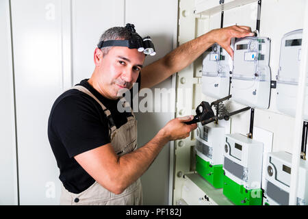 Electrician testing equipment in fuse switch box close up Stock Photo