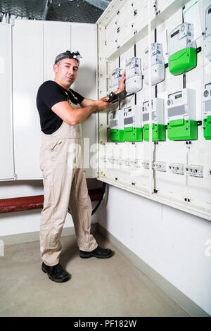 Electrician testing equipment in fuse box or switch box Stock Photo