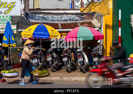 Action in front of a cafe with umbrellas and motorcycles parked under an umbrella. Stock Photo