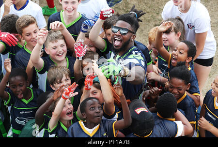 EDITORIAL USE ONLY NFL London Games player Neiko Thorpe of Seattle Seahawks  with school pupils at the NFL Flag Summer Bowl presented by Subway, in  Chiswick Stock Photo - Alamy