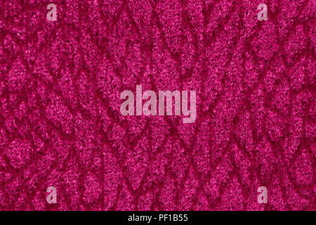 Saturated pink fabric texture with ornament on macro. High resolution photo. Stock Photo