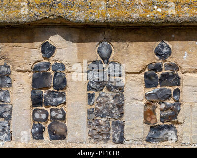 Details of knapped flint and stone church walls Stock Photo