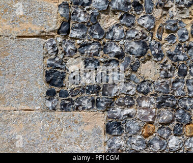 Details of knapped flint and stone church walls Stock Photo