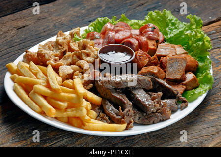 Snacks with fries, crackers, meat, pork, sausage and babercue sauce Stock Photo