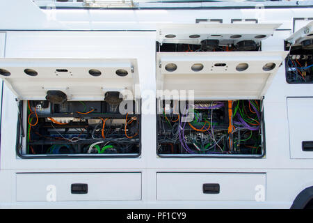 Transmission line behind and electronic cable network the outside broadcasting van. Stock Photo