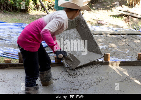 Woman during concreting floors in construction site Stock Photo