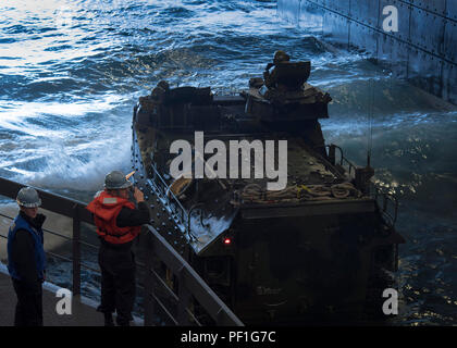 CAMP PENDLETON, Calif. (Feb. 20, 2016) - Sailors assigned to deck department hand signal vehicle movements of amphibious assault vehicles (AAV) onto the main vehicle stowage area during a well deck operation aboard amphibious transport dock ship USS Somerset (LPD 25), as part of Exercise Iron Fist 2016. Iron Fist is an annual bilateral training exercise between the Japan Ground Self Defense Force and Marines to strengthen warfighting capabilities in ship to shore operations. Marines, assigned to the 11th Marine Expeditionary Unit, are currently embarked on Somerset for the final phase of the e Stock Photo