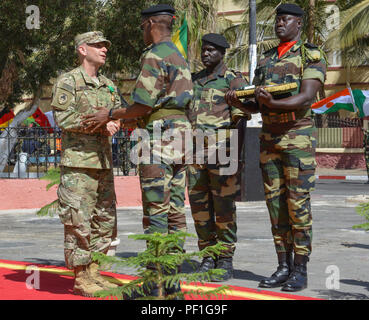 U.S. Army Brig. Gen. Donald C. Bolduc, Special Operations Command-Africa commander, shakes hands with Senegal army Maj. Gen. Mamadou Sow, chief of general staff, after being inducted into the Senegal National Order of the Lion as part of the closing ceremony for Flintlock 2016 in St. Louis, Senegal, Feb. 29, 2016. The National Order of the Lion is the highest category of Senegal’s military awards. Stock Photo